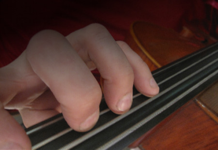 photo of fingers on cello